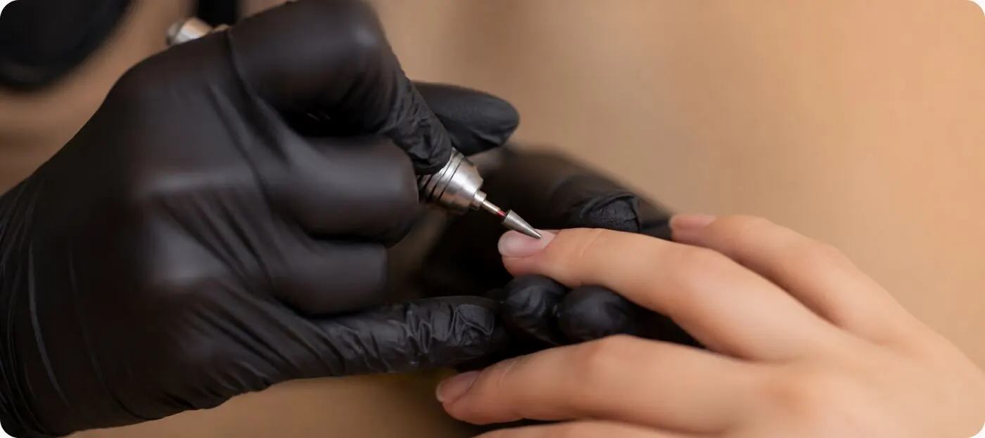 Nail technician using an e-file — join our team